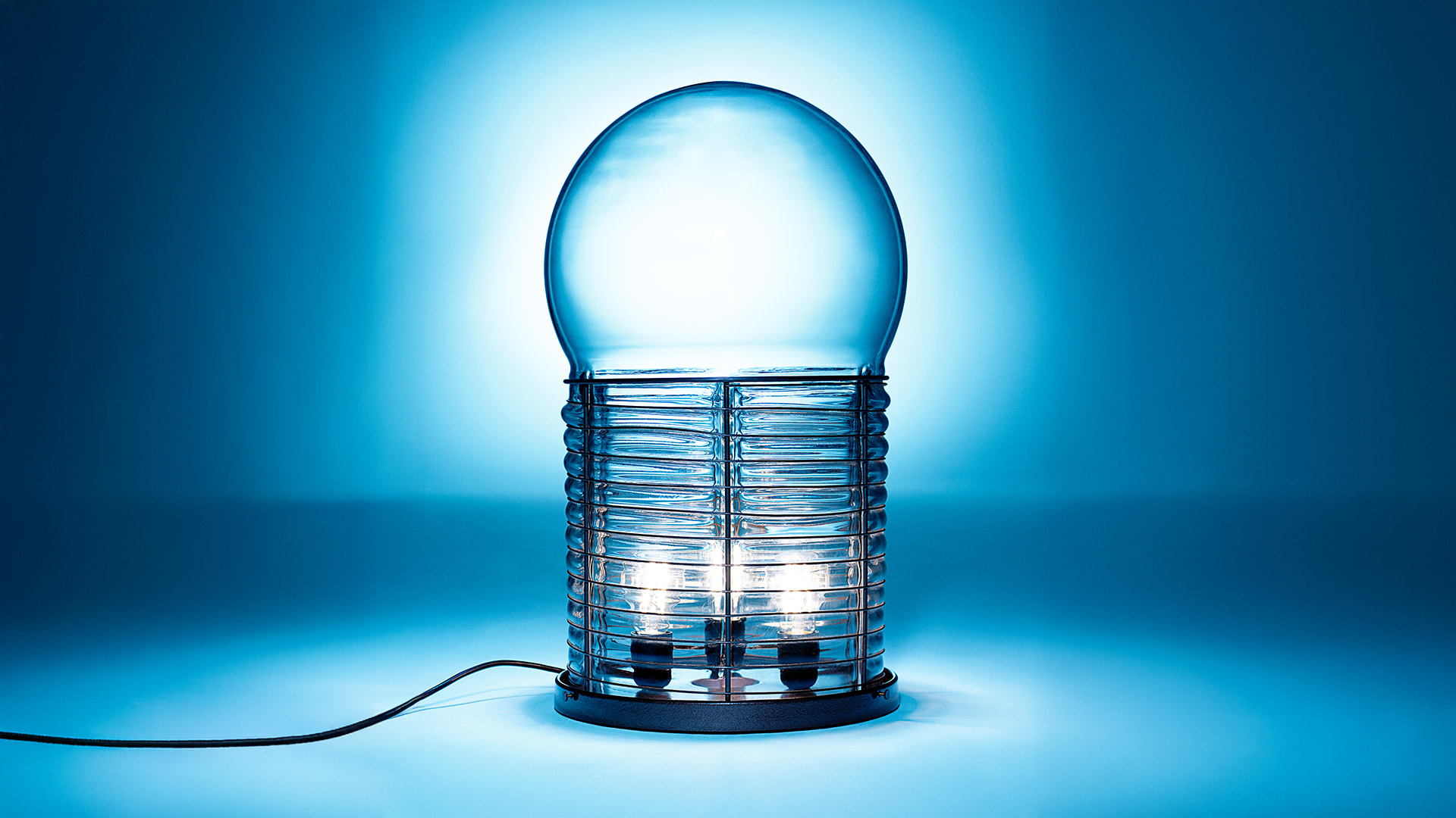 Lampada da tavolo Artemide Alcinoo: globo in vetro satinato su gabbia cilindrica con nervature orizzontali e base in rame