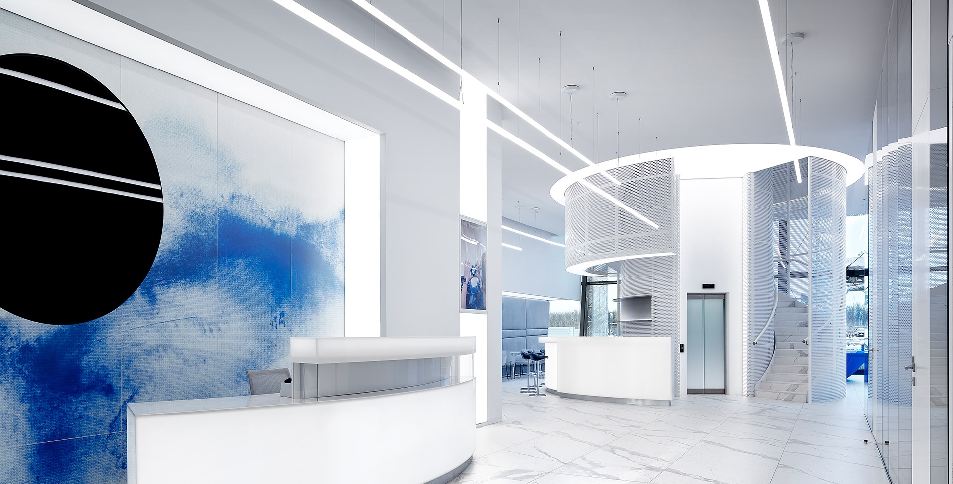 Lounge moderno con sistema Artemide Alphabet of Light su soffitto in legno, poltrone nere, scaffali riviste e zona pranzo con vista città