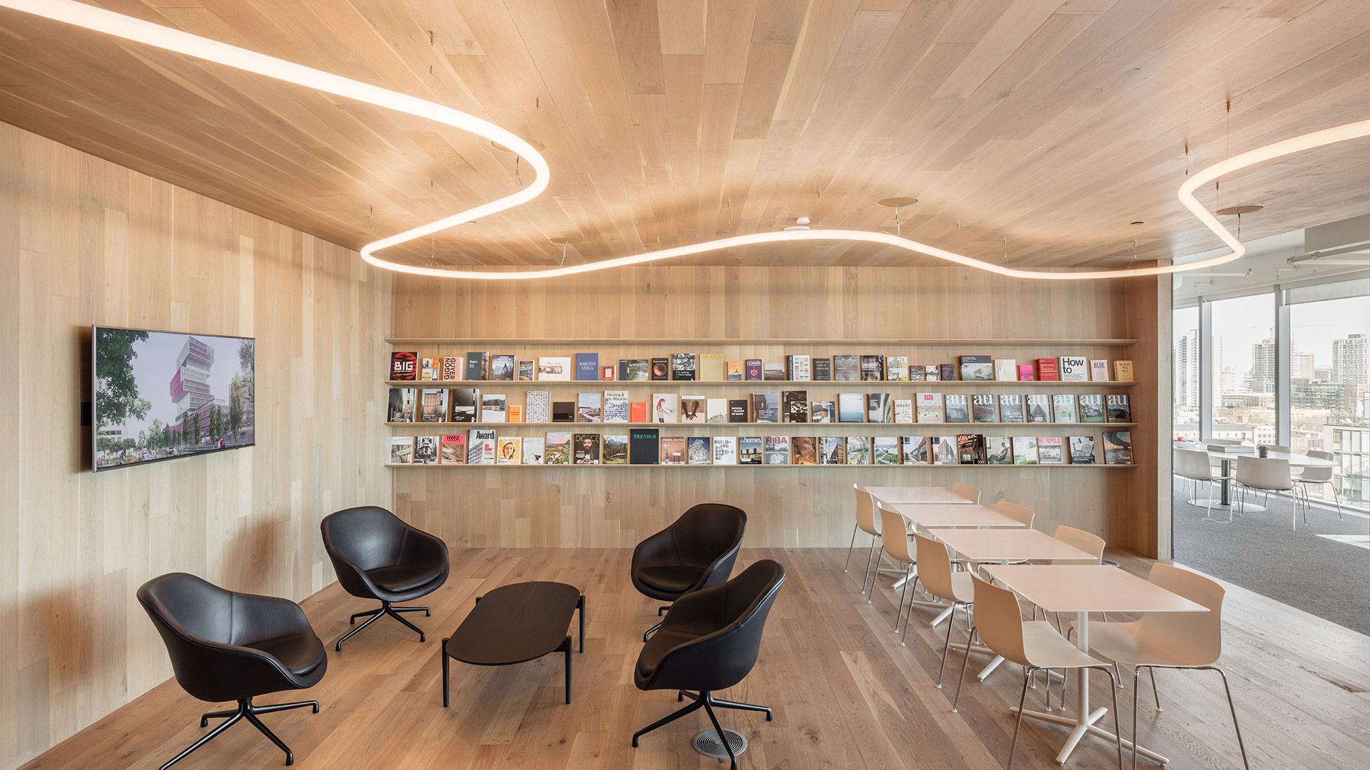 Artemide Alphabet of Light System: modulo lineare LED continuo che forma un'installazione sospesa fluida e curvilinea su parete grigia