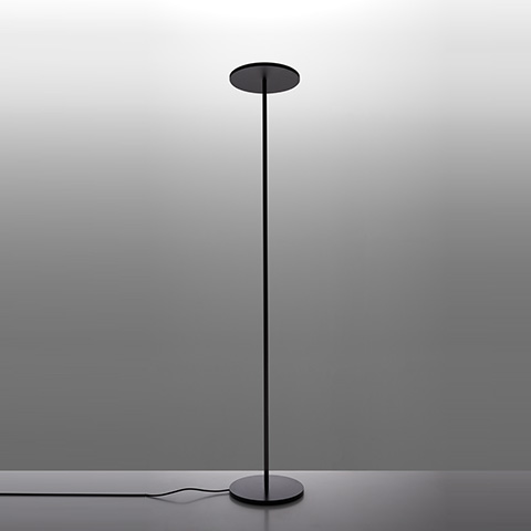 Athena floor lamp by Artemide: slender black stem with circular disc diffuser on top, mounted on a round base
