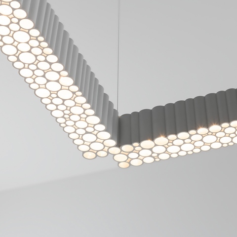 Sospensione Artemide Calipso Linear System: profilo in alluminio grigio a forma di L con diffusori LED circolari che creano un motivo a bolle