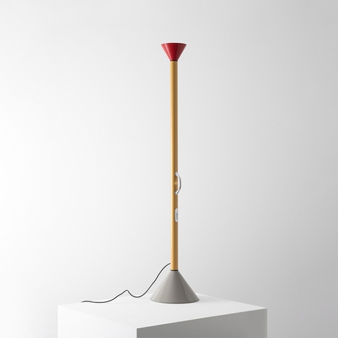 Artemide Callimaco floor lamp: tall slim yellow stem, red conical uplight shade, grey conical base, dimmer switch on stem