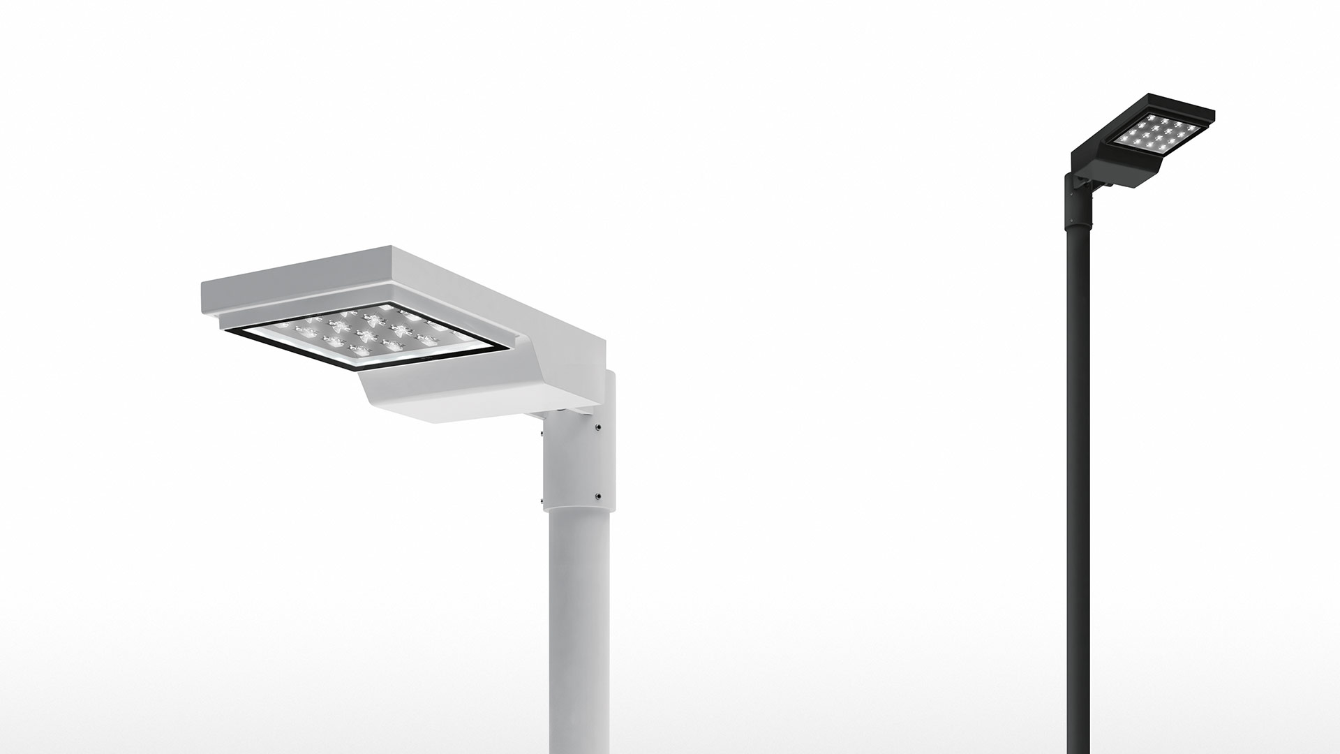 Due lampade da palo outdoor LED Artemide Cefiso: versione bianca a sinistra con braccio regolabile, versione nera a destra su palo dritto alto