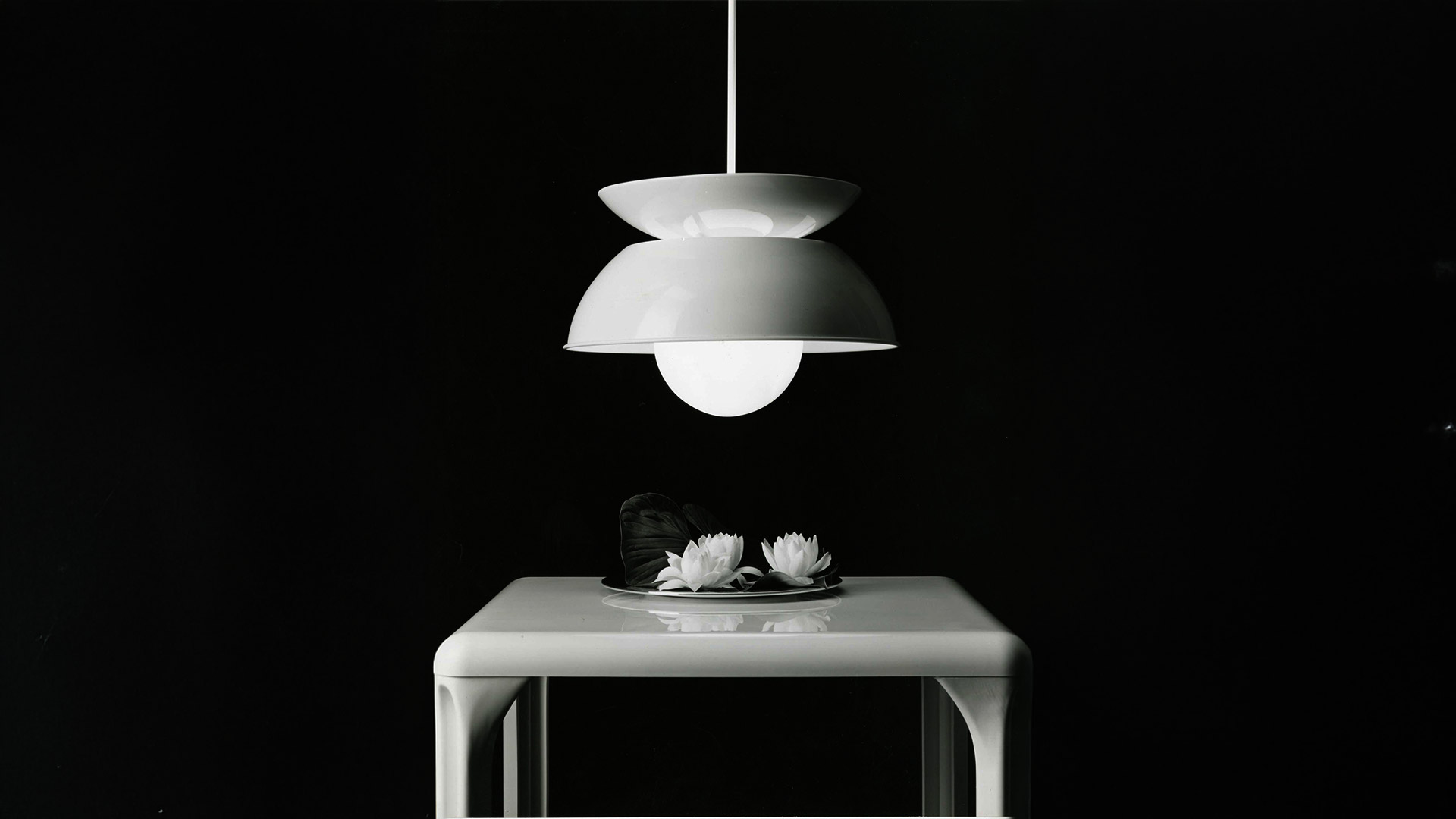 Artemide Cetra pendant lamp in white, featuring a double-layered dome shade and opal glass globe bulb, suspended from ceiling