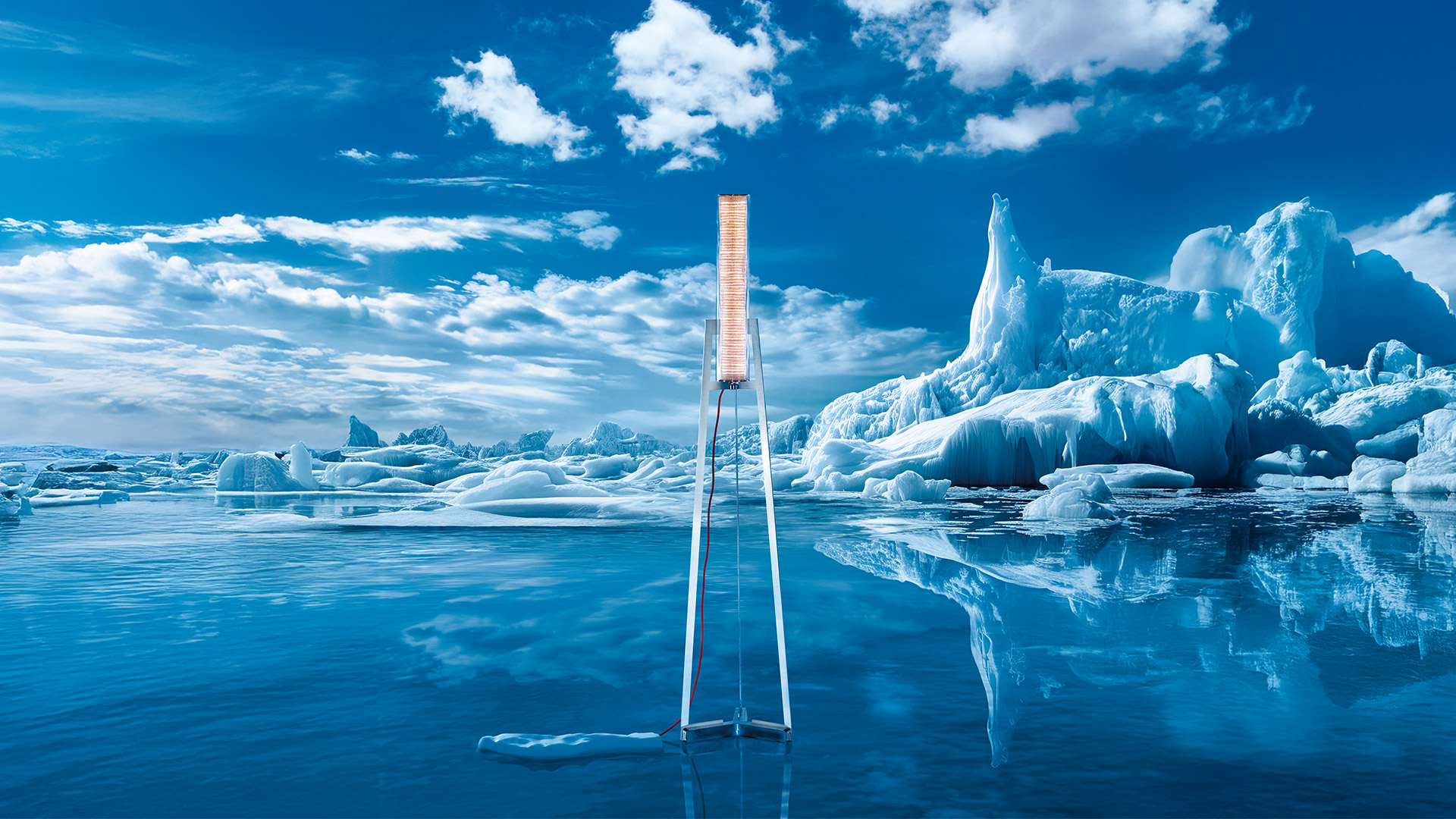 Artemide Criosfera table lamp: cylindrical glass diffuser on metal ruler base with neon orange power cord