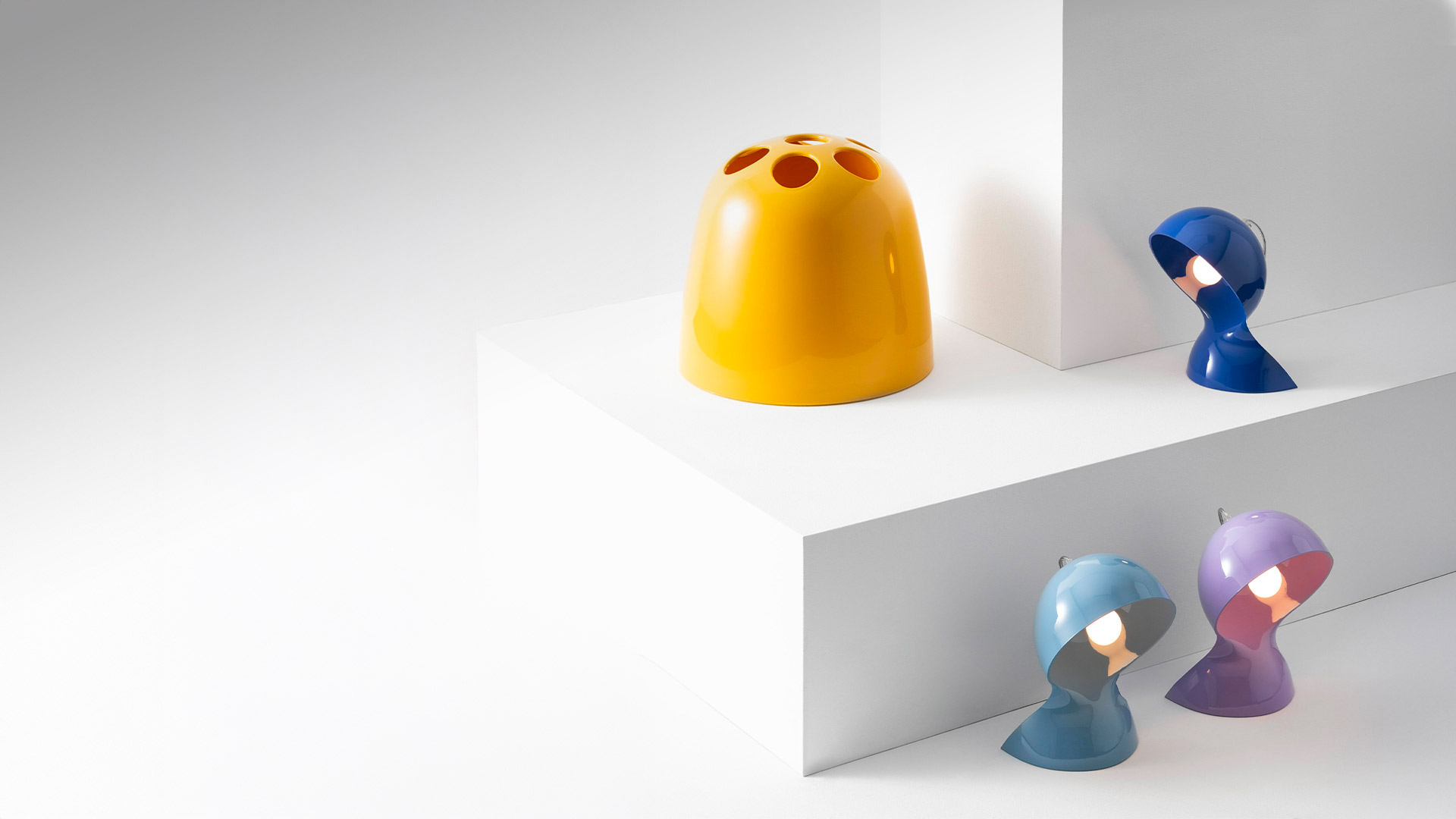 Lampade da tavolo Artemide Dalù in giallo, blu, azzurro e viola, con forma a cupola arrotondata e apertura circolare per luce direzionale