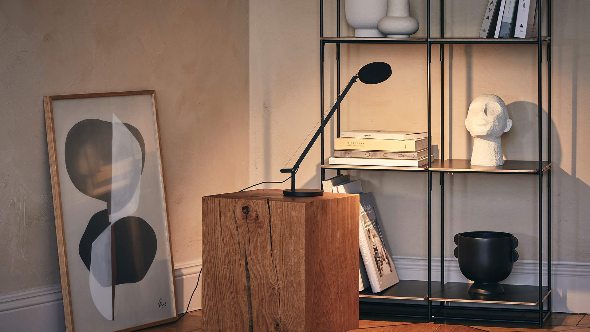 Artemide Demetra Micro table lamp in white with adjustable arm, circular dark reflector head, and round base with black cord