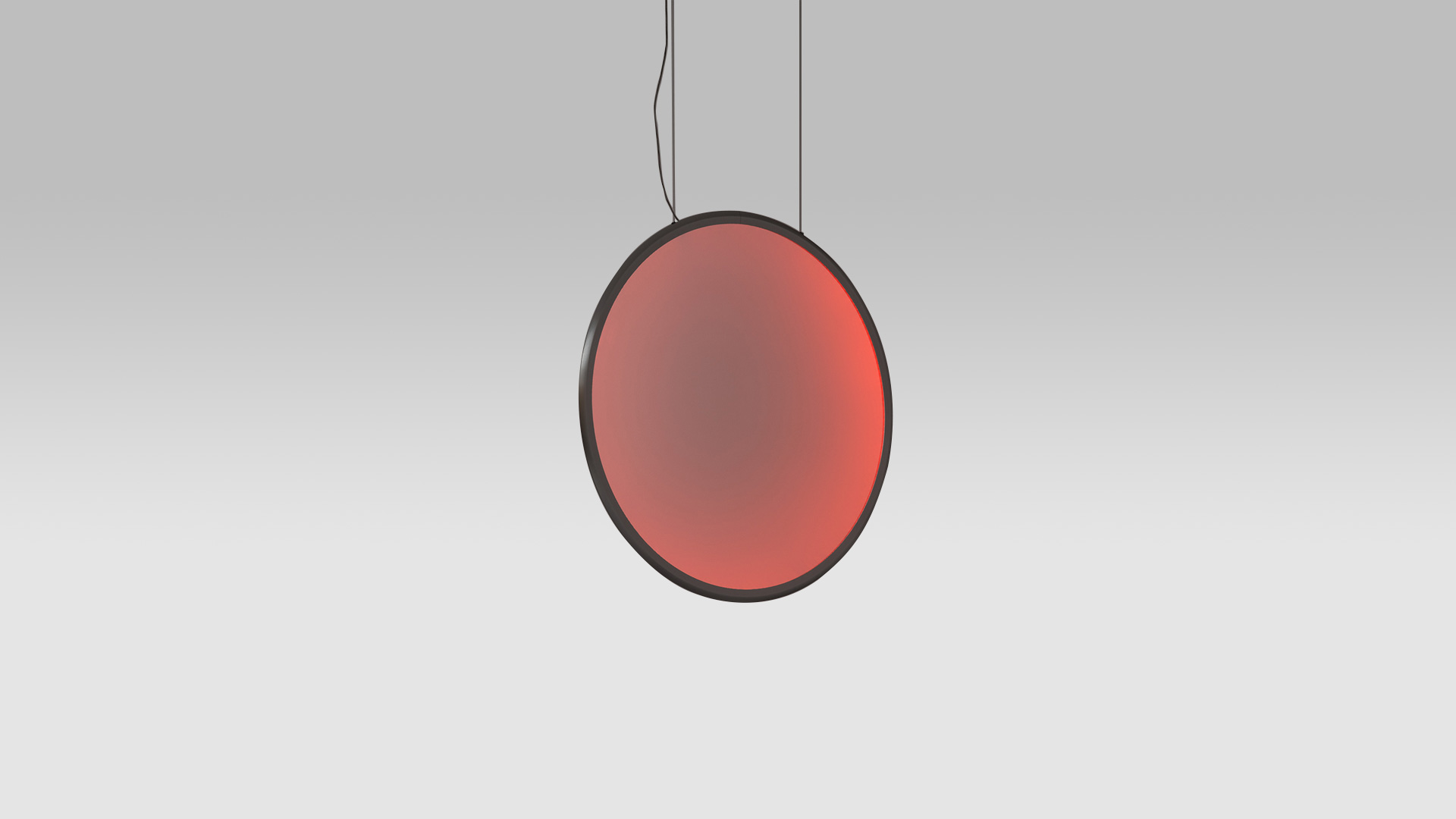 Lampada a sospensione Artemide Discovery: grande disco circolare con cornice scura che emette luce a gradiente rosso caldo, sospesa da cavi neri