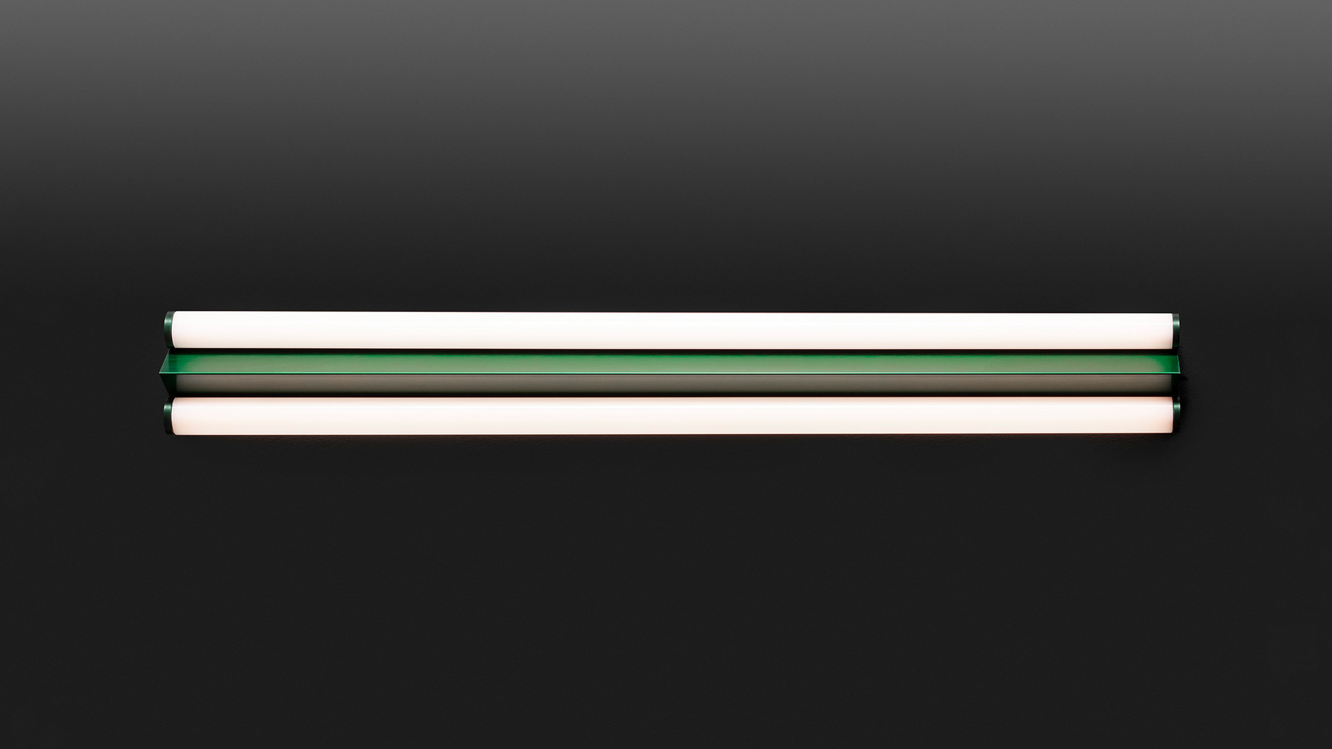 Artemide Dreispitz linear LED wall lamp with two horizontal tubes emitting warm white light and a green central band