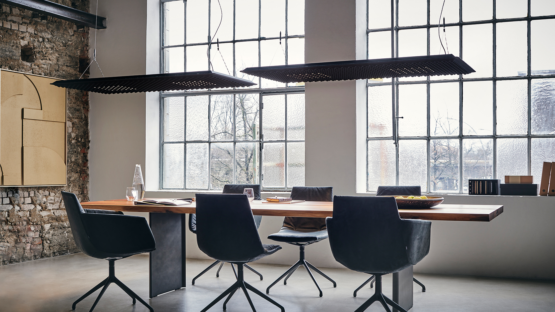 Artemide Eggboard and Eggboard Matrix acoustic ceiling panels with integrated lighting, in beige and yellow, mounted between industrial ducts
