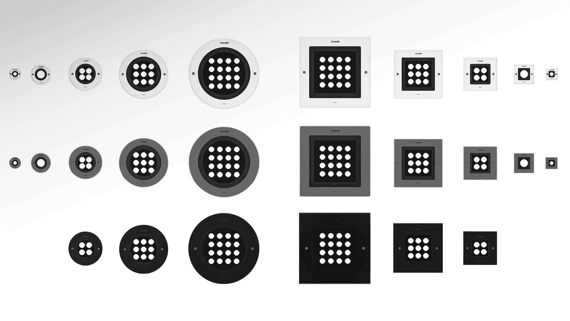 Downlight quadrati Artemide Ego 220 a filo pavimento in cemento illuminano il percorso esterno di un edificio residenziale moderno al crepuscolo.