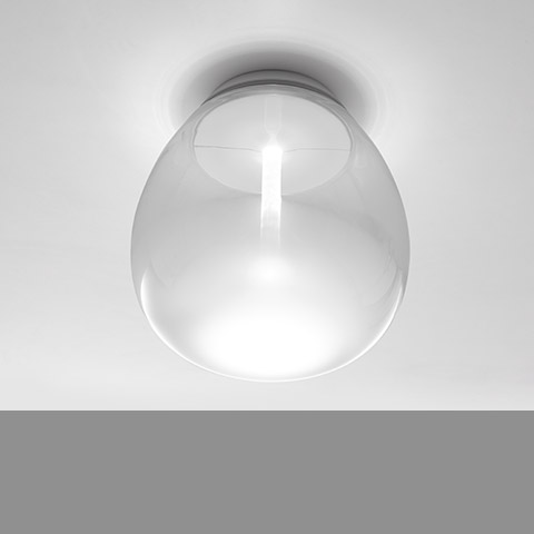 Artemide Empatia wall/ceiling lamp: transparent blown glass dome diffuser emitting soft white light, mounted flush on ceiling