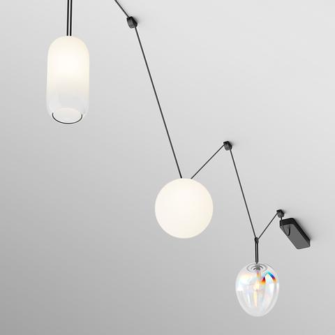 Artemide Funivia Plug: three pendant lights on black cables—oval white glass, opal sphere, and iridescent crystal drop