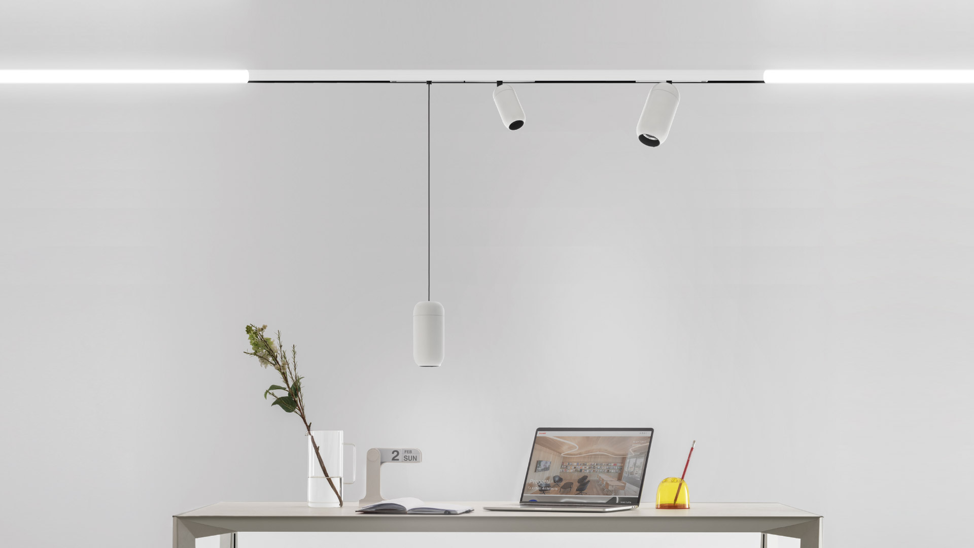 Sospensioni Artemide Gople System in nero e bianco vicino a un anello LED circolare luminoso e una grande installazione LED curva in un interno moderno