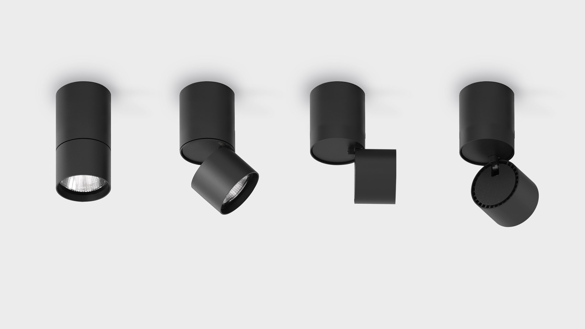 Due faretti da soffitto Artemide Hoy Spot SMD bianchi: sinistro inclinato verso il basso, destro angolato con luce LED calda emessa dal corpo cilindrico