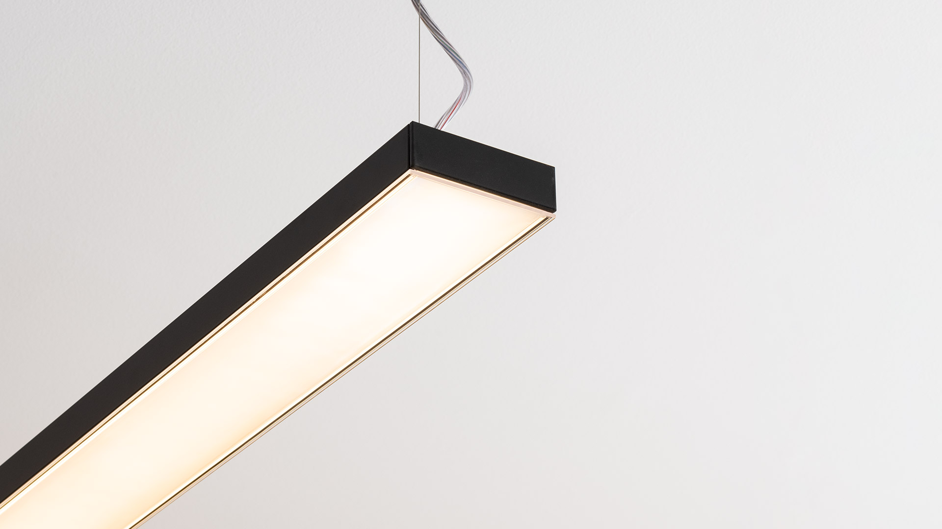 Artemide Hoy Linear Stand Alone ceiling lamp: slim white rectangular LED fixture emitting warm white light, surface-mounted on ceiling