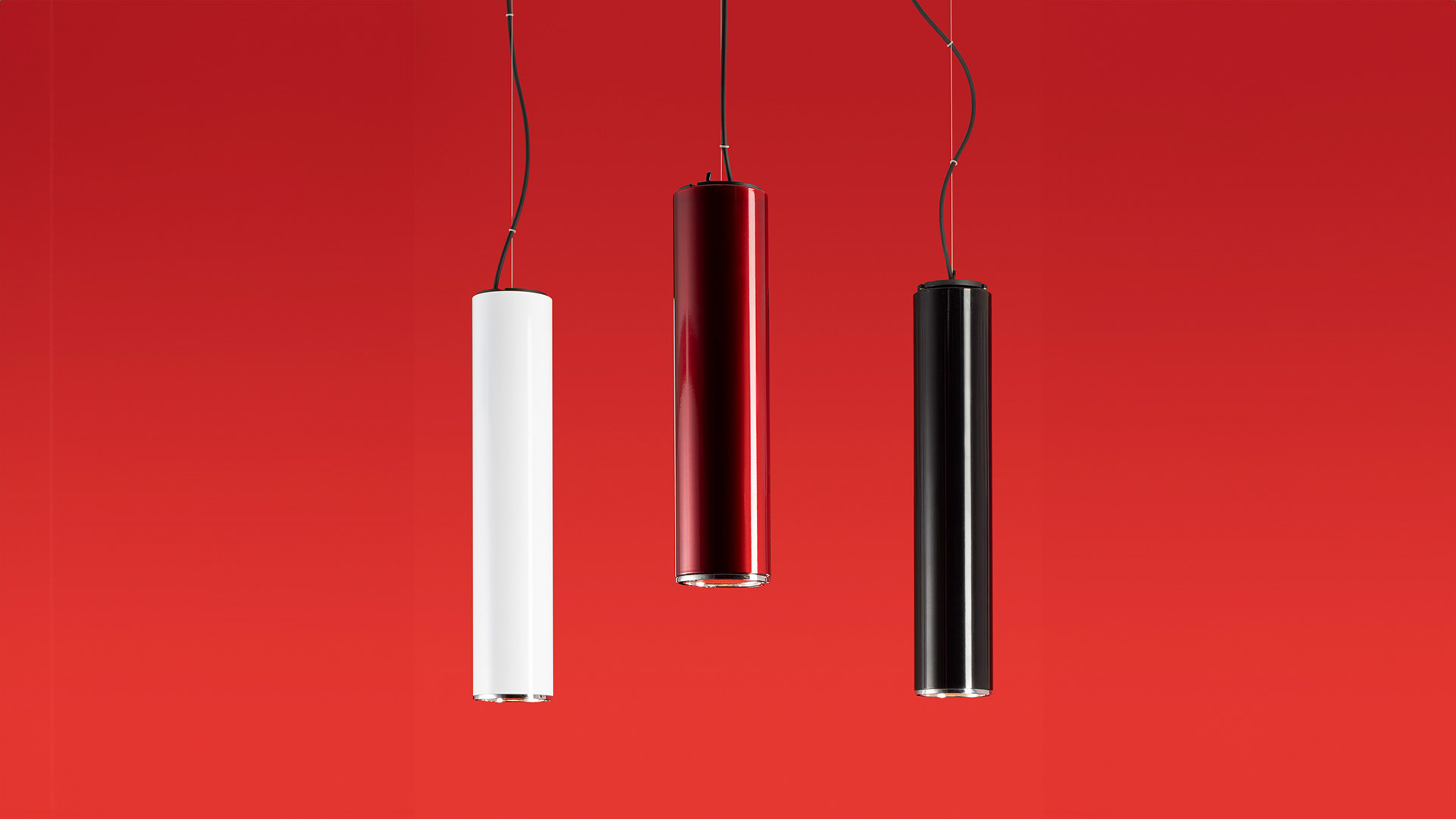Artemide Ilio wall lamp in glossy black finish, sleek triangular profile mounted on white wall, minimalist design