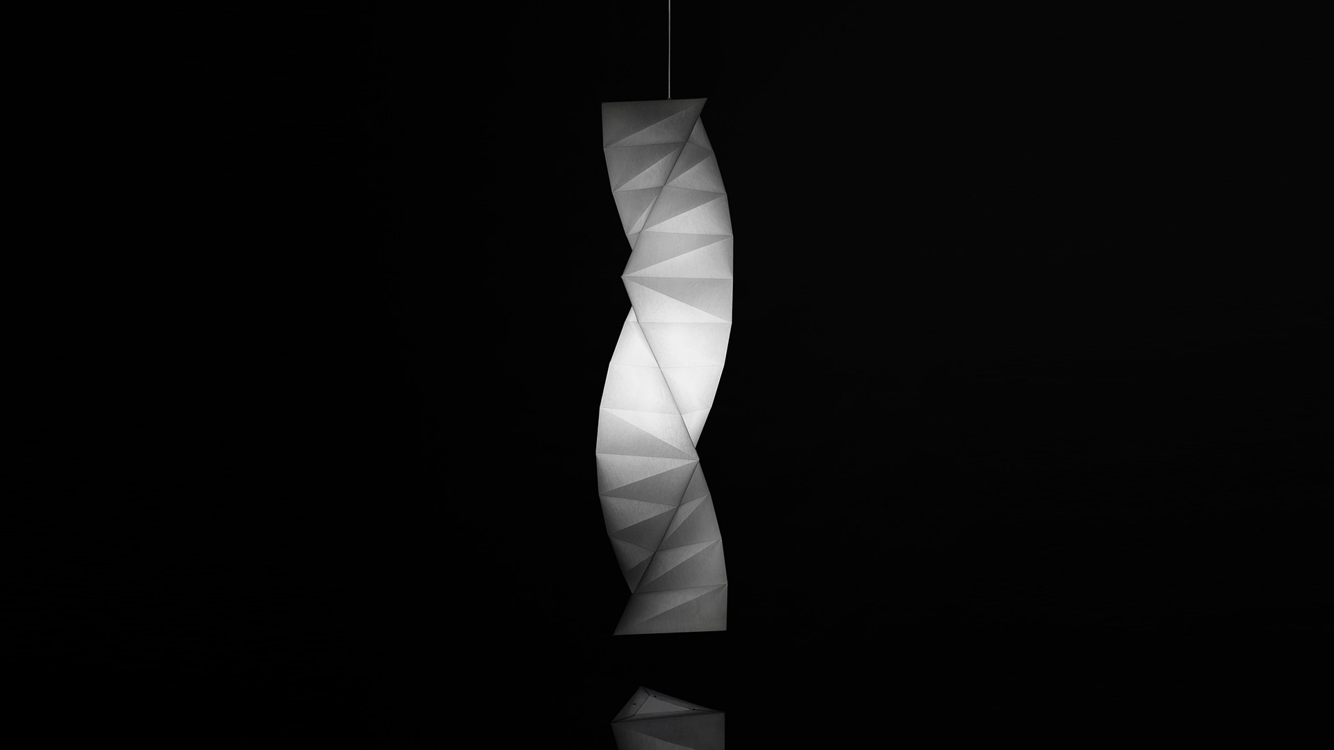 Lampada a sospensione Artemide In-Ei Issey Miyake Tatsuno-Otoshigo: diffusore bianco a forma origami ritorto luminoso su sfondo scuro