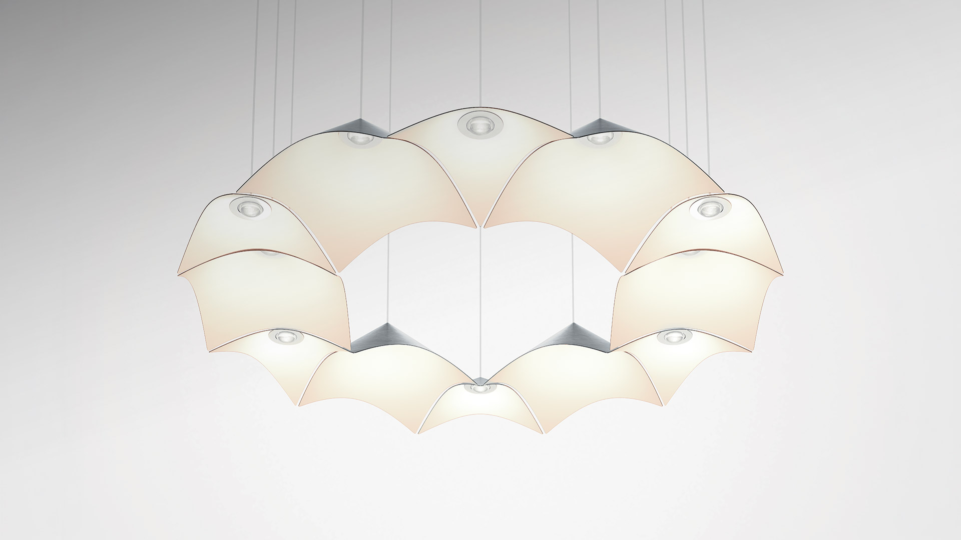 Artemide Iperbole pendant lamp: circular arrangement of silver origami-shaped modules suspended by black cables on blue background