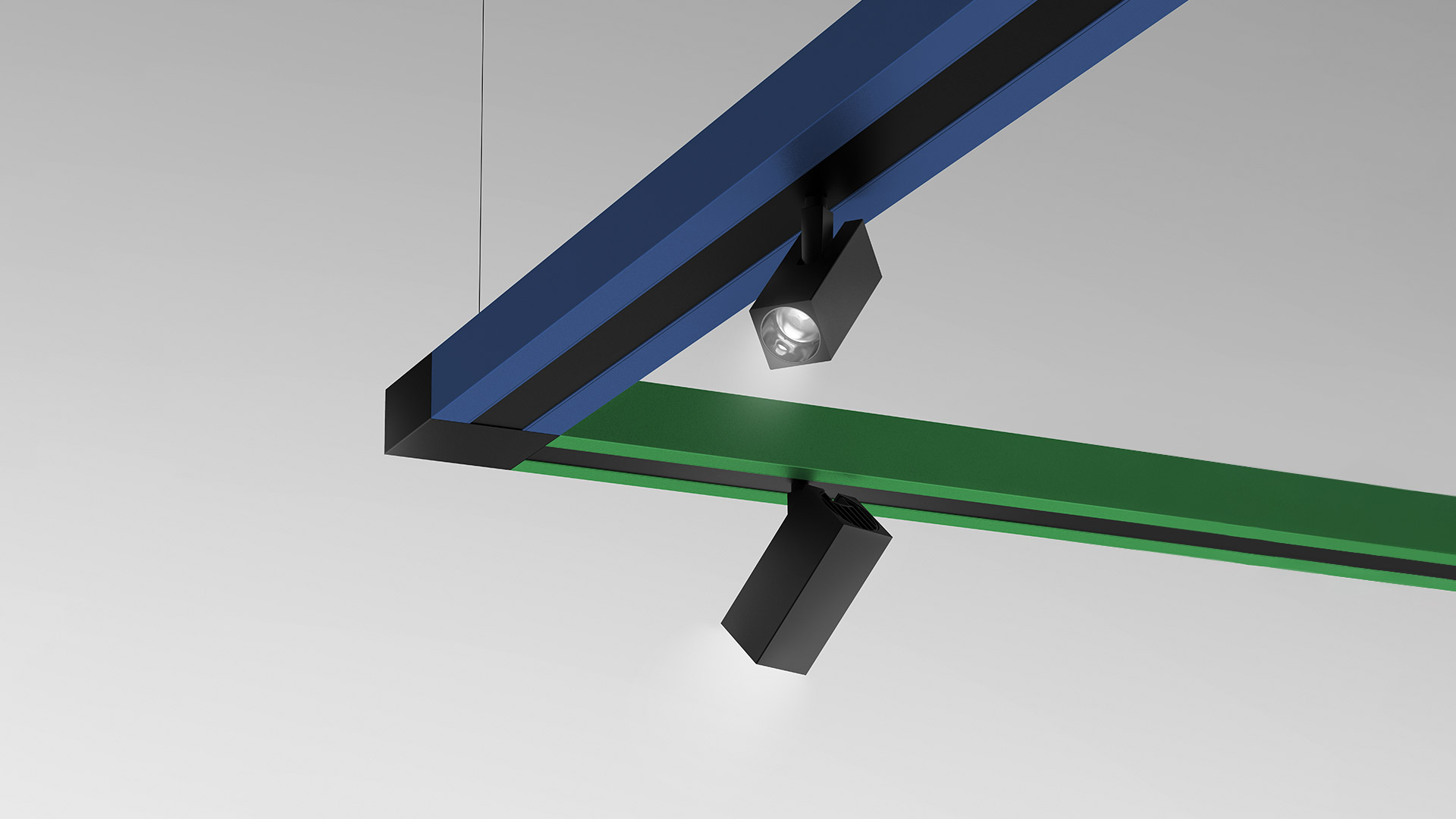 Sistema di illuminazione a sospensione Katà Métron con profili modulari angolari in rosso, verde, blu, giallo e bianco appesi al soffitto