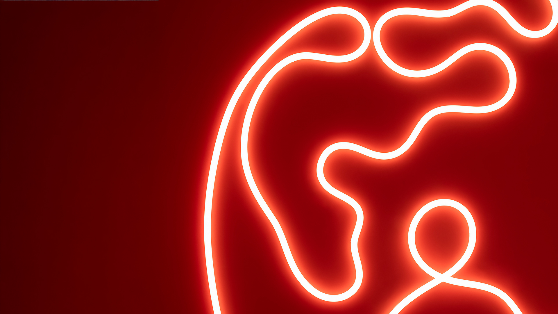 Luce al neon rossa luminosa che forma un profilo femminile astratto a linea continua su sfondo rosso scuro