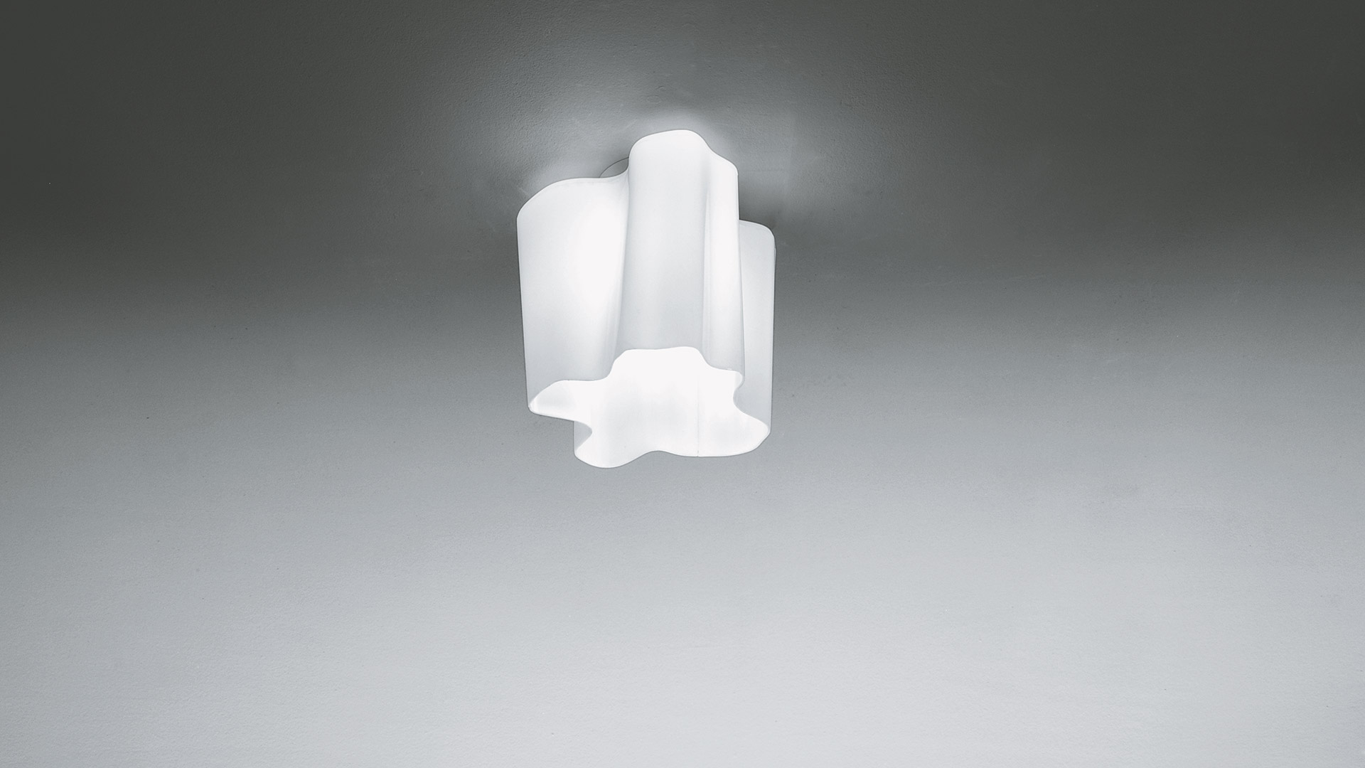 Lampada da soffitto Artemide Logico con diffusore in vetro opalino bianco a forma organica floreale, montata a filo soffitto