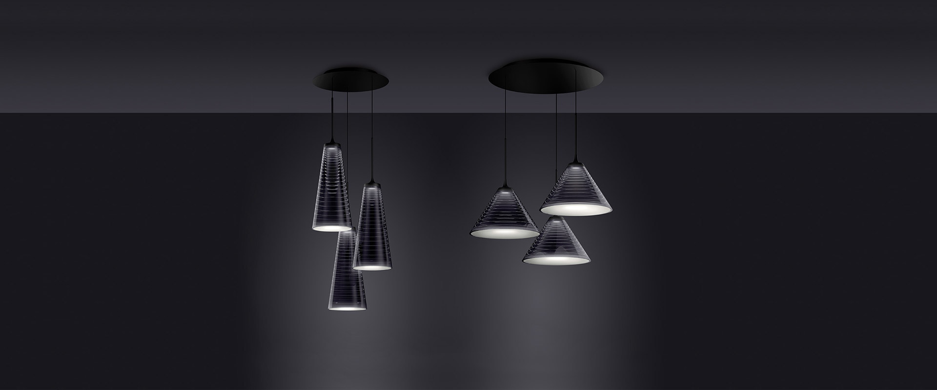 Lampada a sospensione Artemide Look at Me con paralume conico in metallo scuro e diffusore opale, appesa a un cavo nero