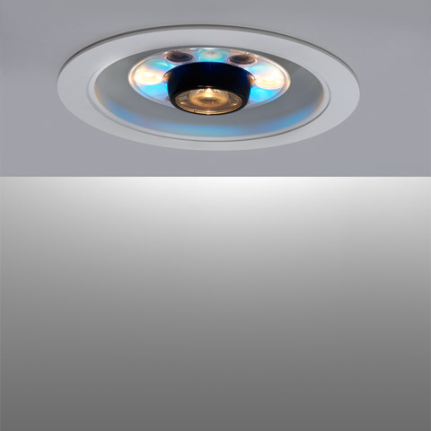 Artemide LoT RGB recessed ceiling light with central halogen bulb surrounded by blue RGB LEDs in a white circular trim