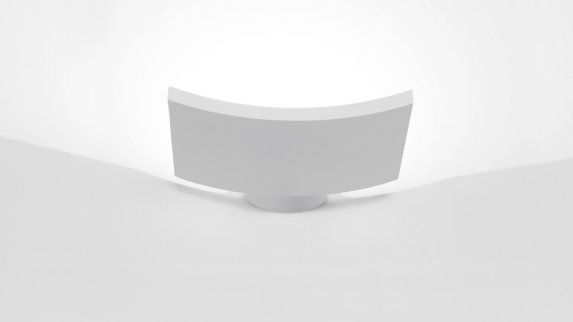 Artemide Microsurf wall lamp, white curved rectangular diffuser with concave front face, minimalist design, mounted on wall