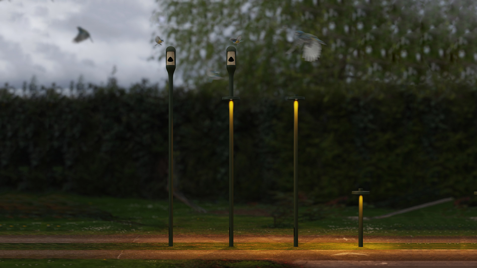 Lampade da esterno Artemide Needoo verde scuro, altezze variabili, luce gialla calda, installate in un parco al crepuscolo