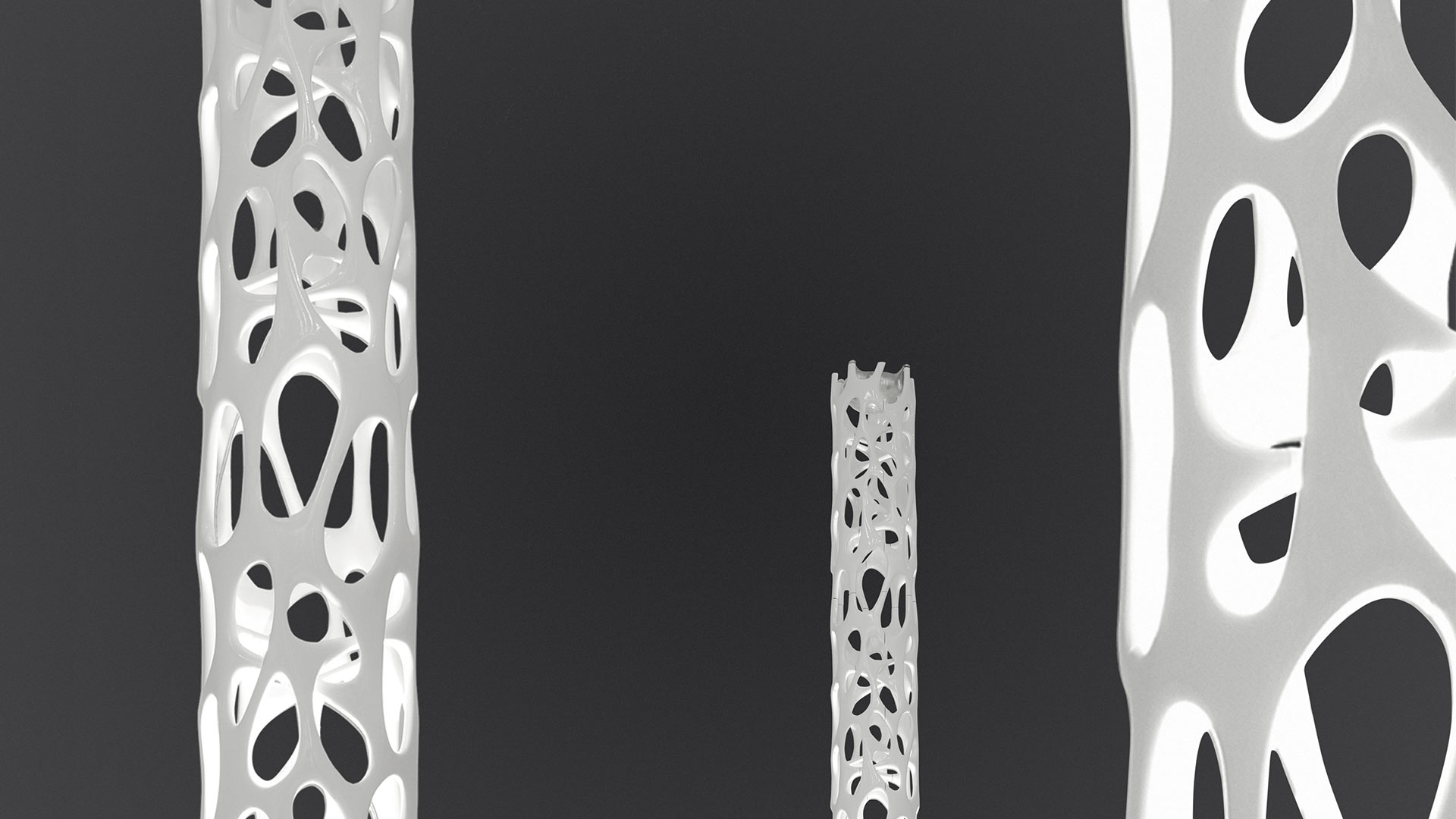 Artemide New Nature floor lamp: tall cylindrical column with organic leaf-pattern cutouts in white, emitting warm light upward