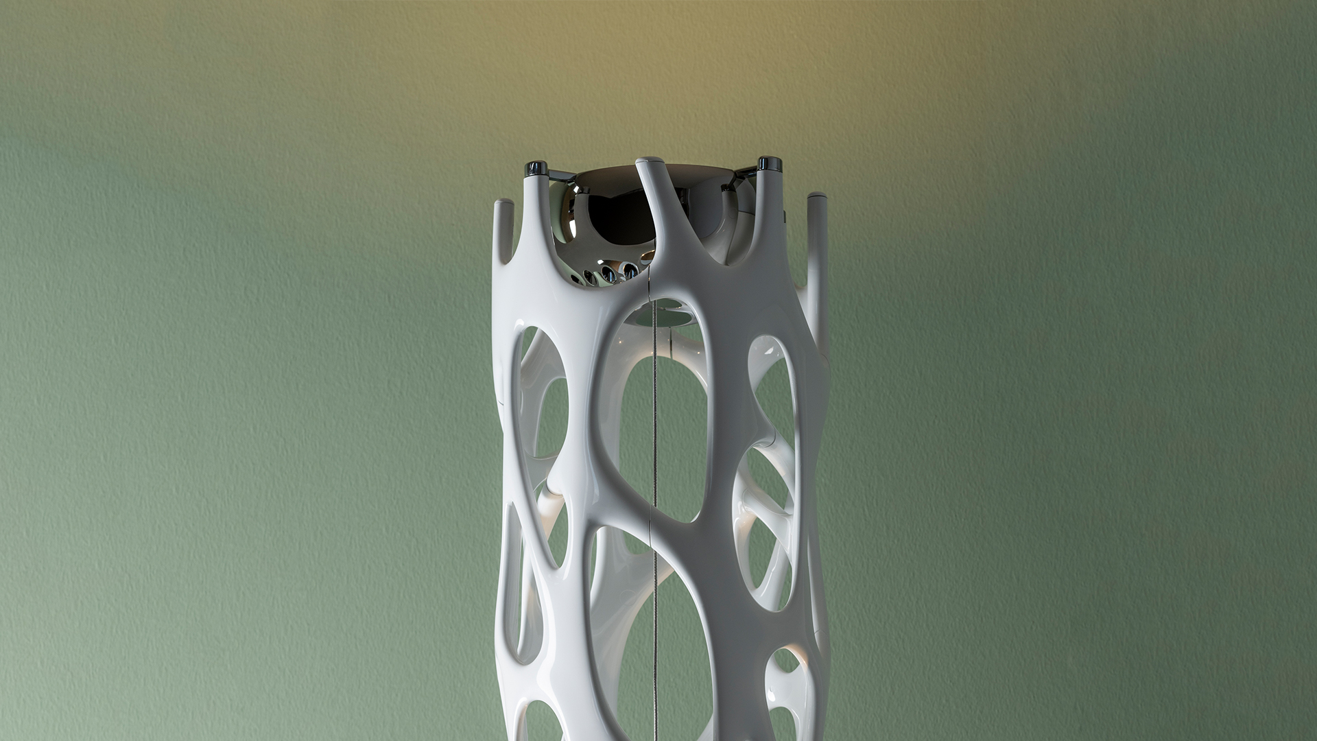 Artemide New Nature floor lamp: tall white column with organic biomorphic cutouts and a chrome reflector at the top