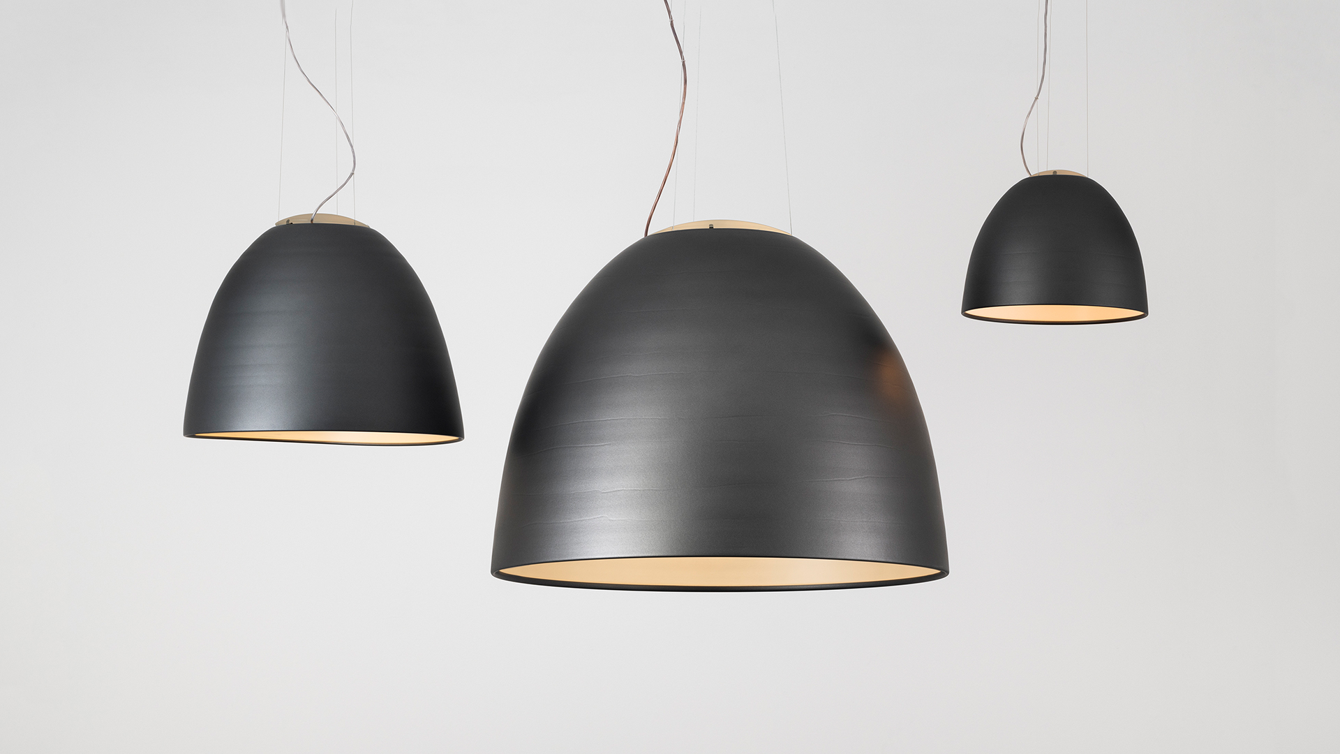 Lampada a sospensione Artemide Nur 1618 con ampio paralume a cupola in alluminio finitura grigia, sospesa da sottili cavi