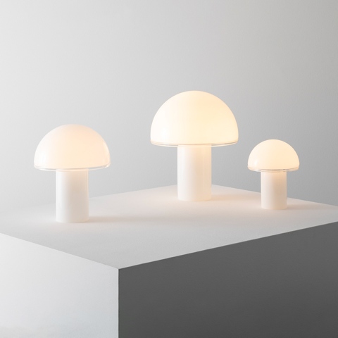 Three Artemide Onfale table lamps in white opal glass, mushroom-shaped, displayed in small, medium, and large sizes on a white surface
