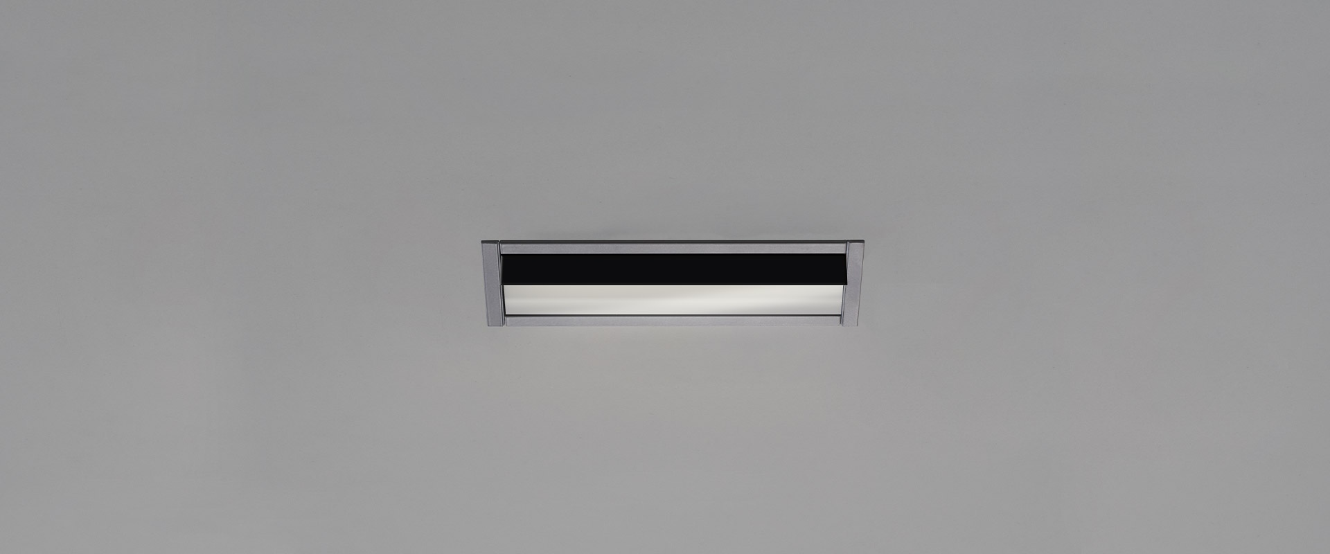 Artemide Sharp Wallwasher recessed ceiling light: slim rectangular fixture with black anti-glare shield and white diffuser strip