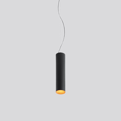 Tagora Sospensione 80 by Artemide: slim black cylindrical pendant lamp with warm gold interior, suspended by a thin cable