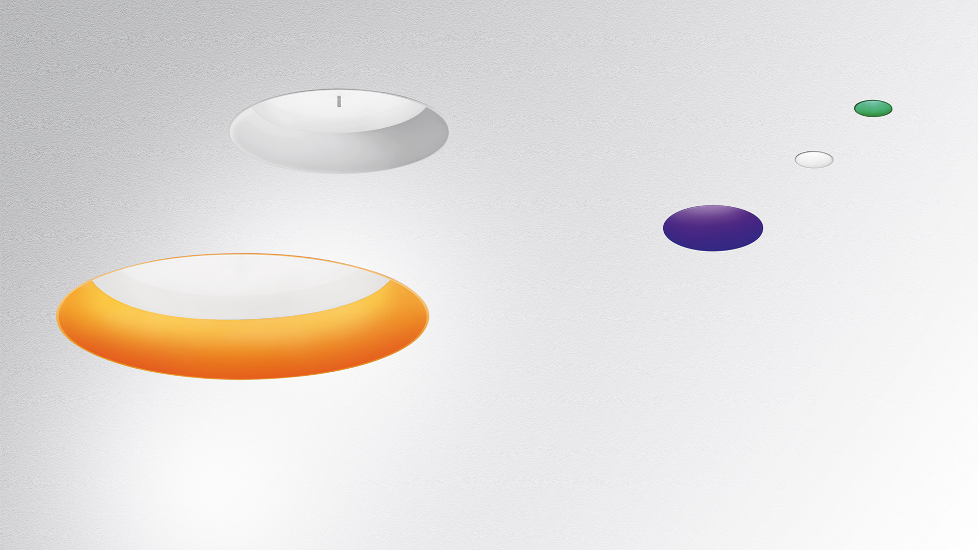 Lampade a sospensione Artemide Tagora: luci a disco bianche e arancioni, con punti colorati che mostrano varianti viola, verde e bianco