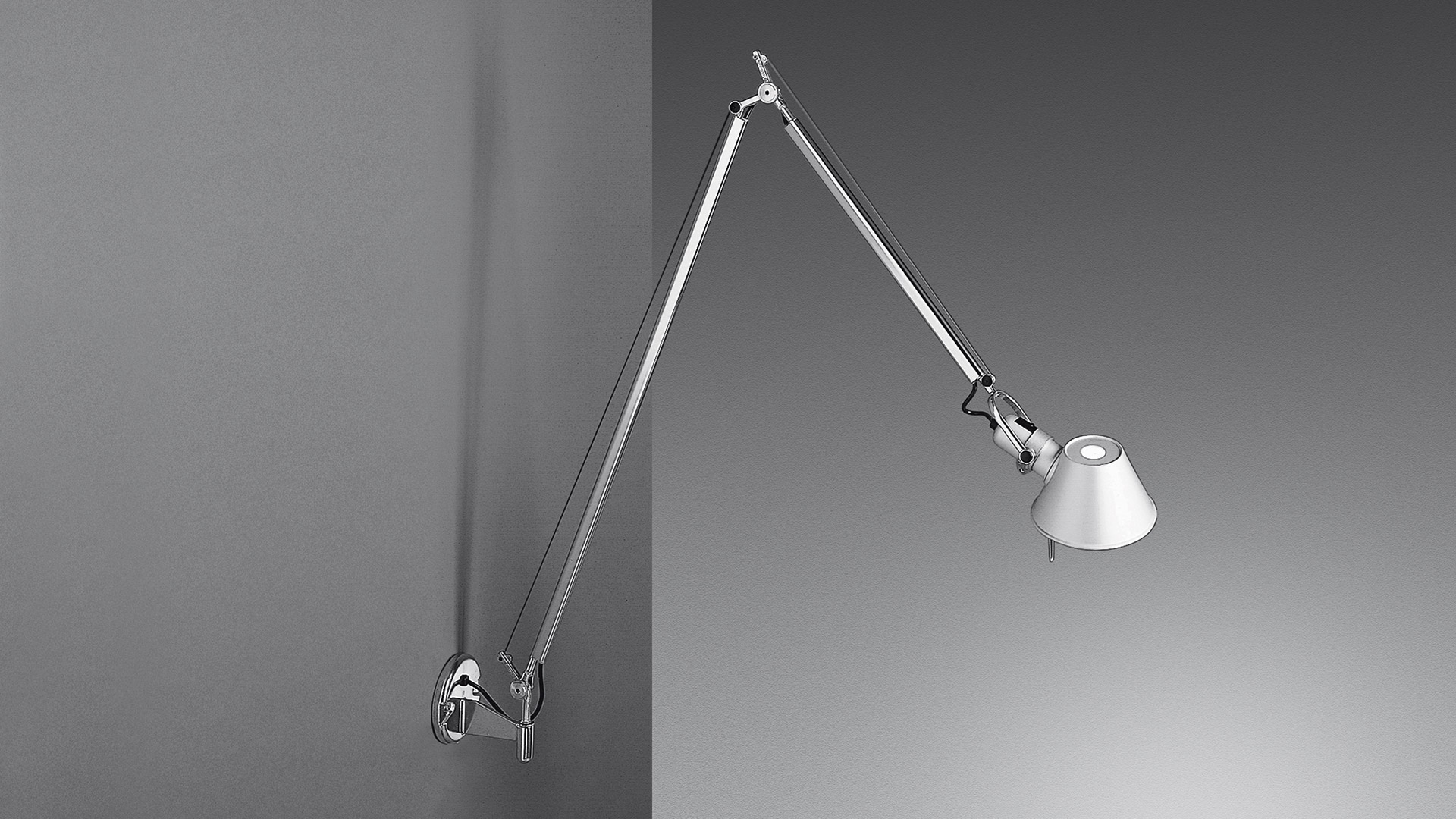 Lampada da parete Artemide Tolomeo Parete in alluminio con doppio braccio articolato e paralume conico, montata su parete grigia