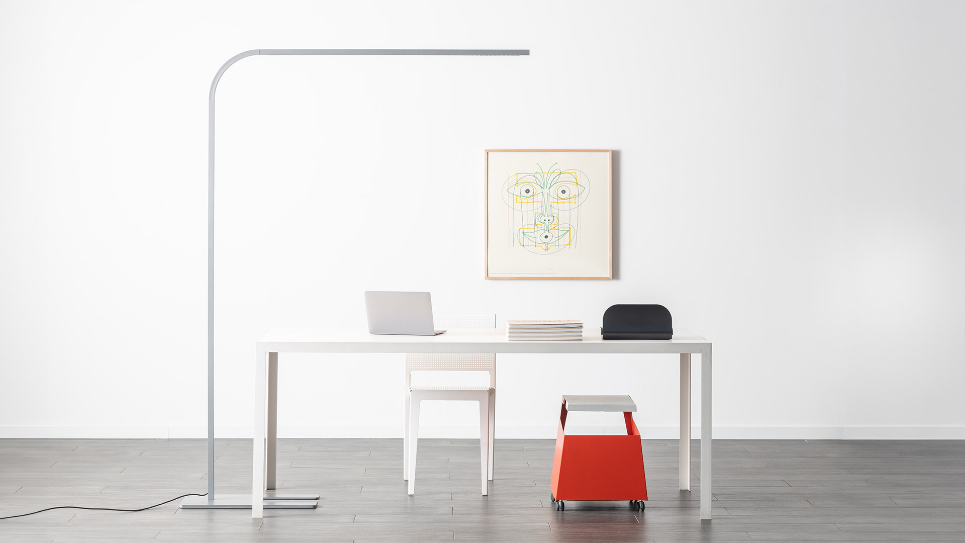 Two Artemide Turn Around Floor lamps in silver, featuring ultra-slim curved stems with horizontal LED bars on flat rectangular bases