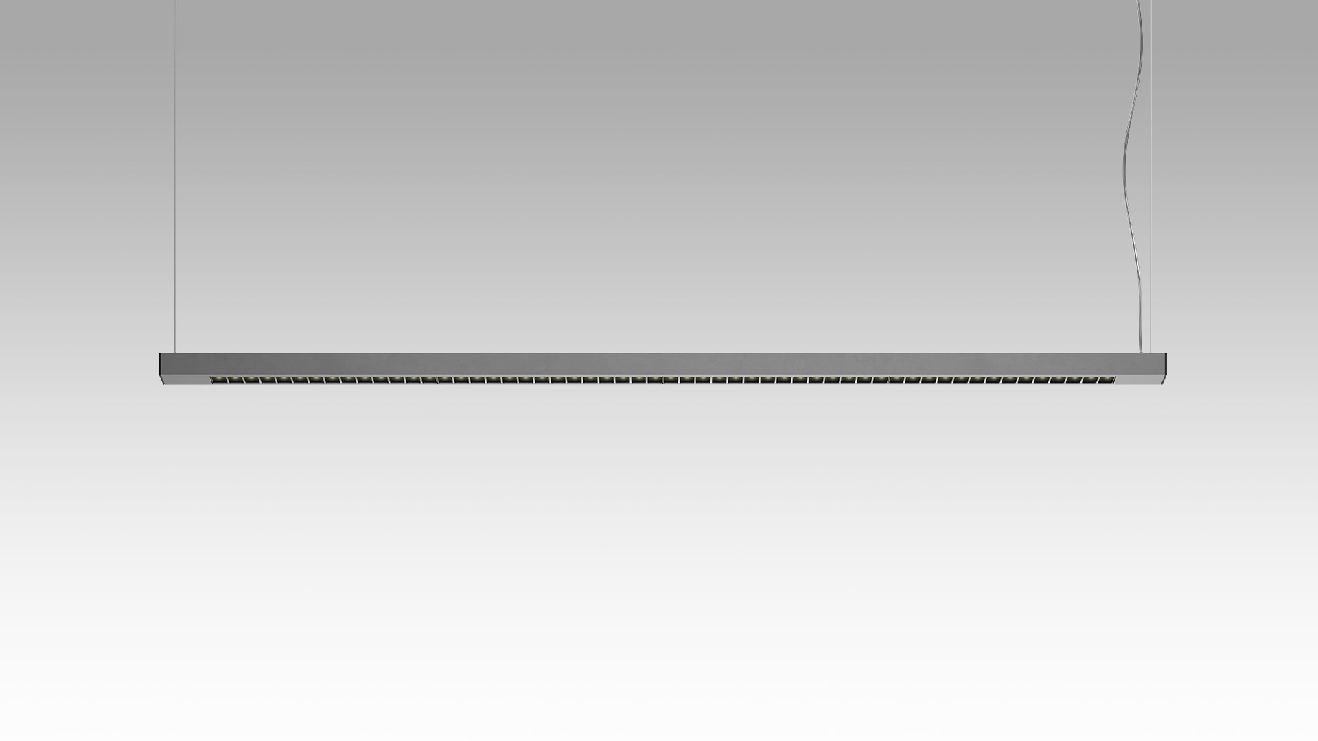 Artemide Turn Around Sospensione: sottile barra LED orizzontale grigio scuro, sospesa da due cavi, con moduli luce direzionali lungo tutta la lunghezza