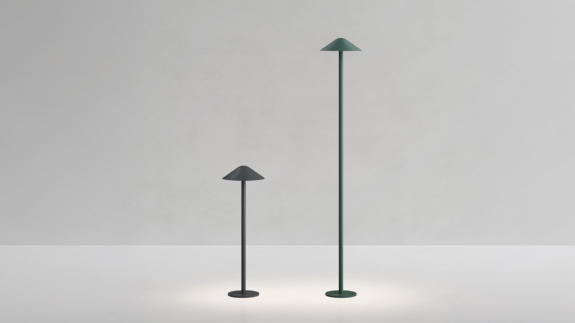 Lampada da esterno Artemide Vea Bollard: palo verde scuro sormontato da un ampio paralume conico che emette luce bianca calda verso il basso
