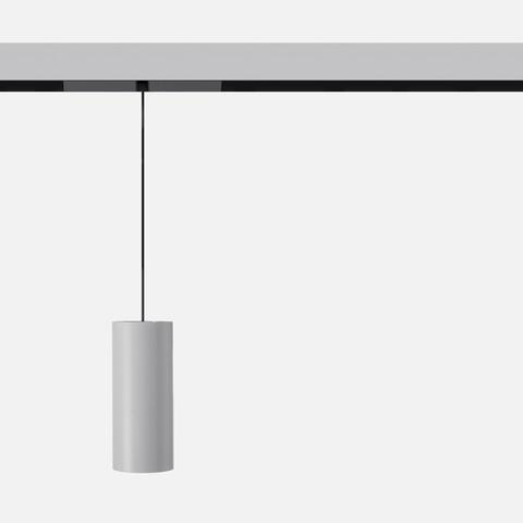 Artemide Vector Pendant Magnetic: cylindrical grey pendant lamp hanging from a black magnetic track rail on a thin black cord