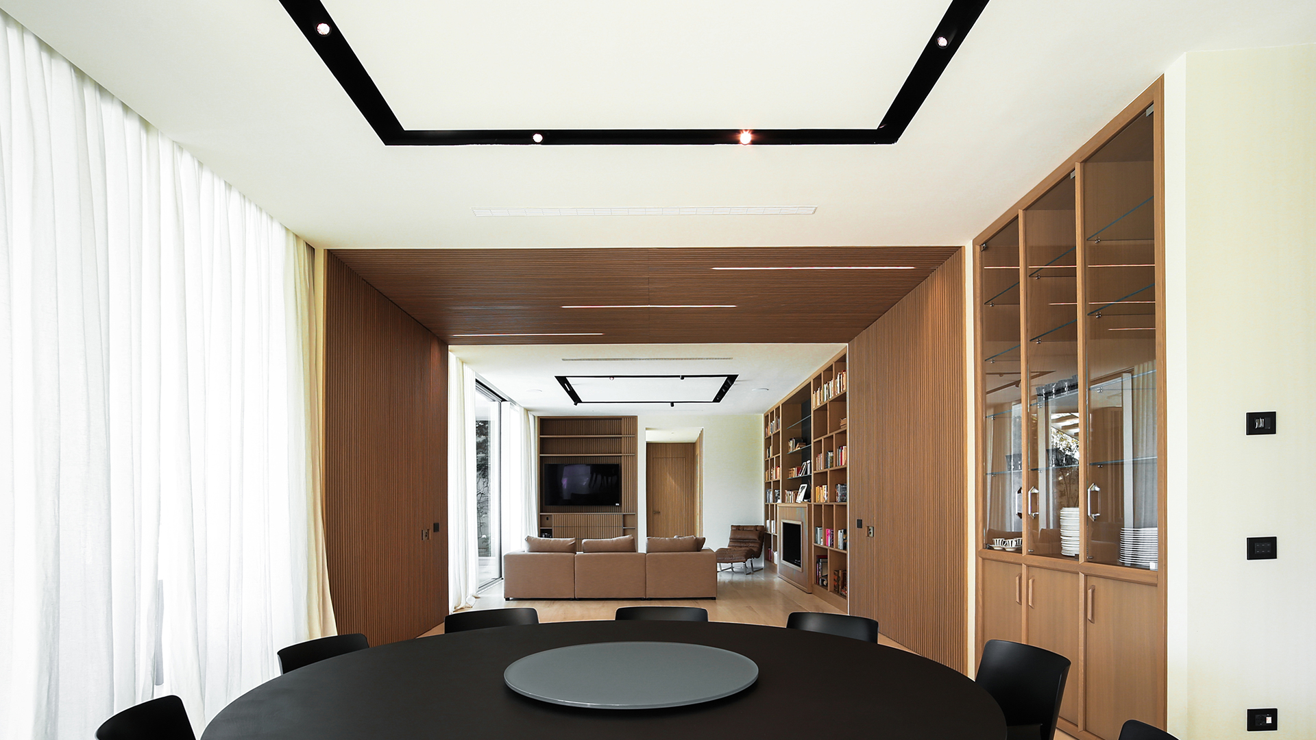 Artemide Vector Channel recessed ceiling system with three adjustable black cylindrical spotlights mounted on a sleek black linear track