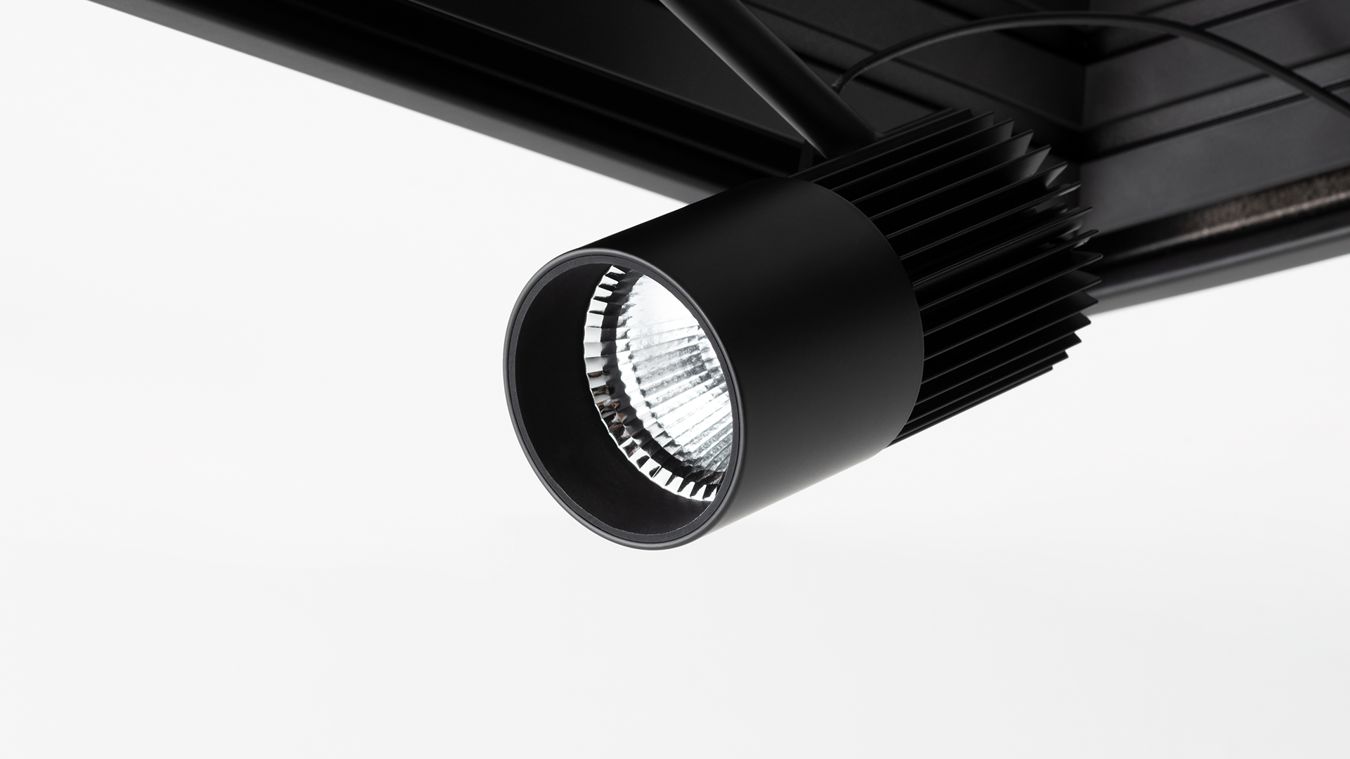 Two black recessed ceiling spotlights: left single-head Vector Channel flush mount, right dual-head Vector adjustable directional LED spots