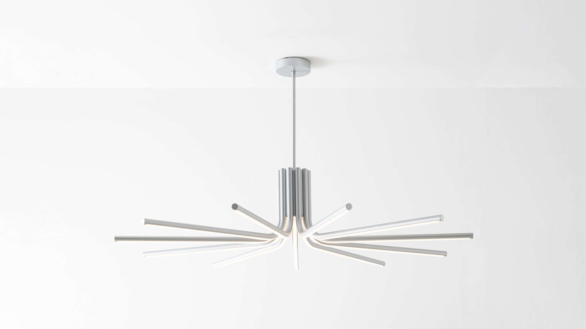 Artemide Veil floor lamp: slender gold stem with angled top, cylindrical metal base, beside two green upholstered ottomans